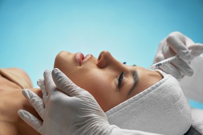 Cosmetic botox injection in female forehead.